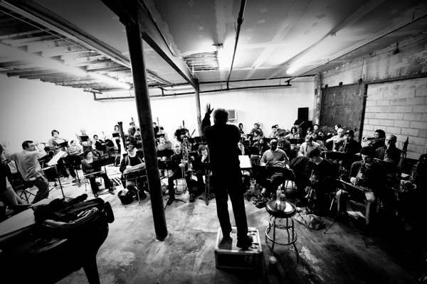 Tri Centric Foundation photograph, a black-and-white photo of a conductor and a small ensemble